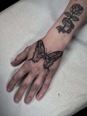 A stunning dotwork butterfly tattoo by artist Dominga Longo, combining intricate details with illustrative style.