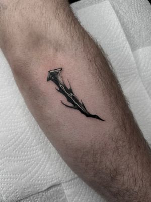 Get an edgy and unique illustrative tattoo of a stake and nail by artist Dominga Longo. Perfect for those seeking a bold design.