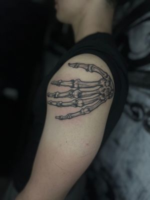 Experience the artistry of Dominga Longo with this illustrative tattoo featuring a skeleton hand design.