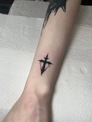 Experience the fusion of traditional and contemporary styles with this illustrative neo tribal cross tattoo by the talented artist Dominga Longo.