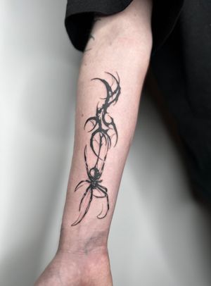 Get a fierce and intricate blackwork spider tattoo with tribal influences by the talented artist Dominga Longo. Perfect for those who are looking for a unique and bold design.