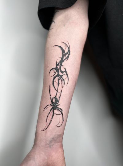 Get a fierce and intricate blackwork spider tattoo with tribal influences by the talented artist Dominga Longo. Perfect for those who are looking for a unique and bold design.