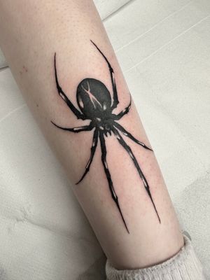 Get inked with a striking illustrative black widow spider tattoo by the talented artist Dominga Longo.