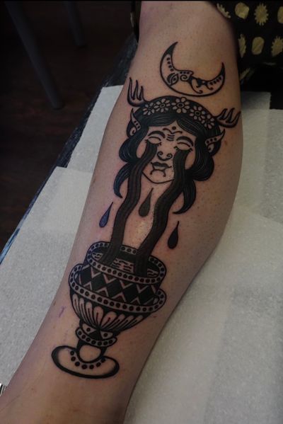 Get mesmerized by this unique tattoo design featuring a moon, vase, and woman by the talented artist Treubhan.