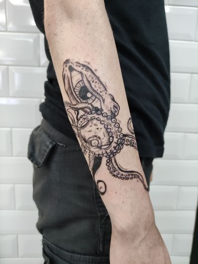 Get inked with Adam McDade's unique design featuring an octopus, monster, and eye in a captivating illustrative style.