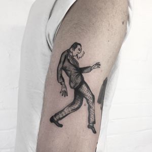 Get lost in the rhythm with this illustrative tattoo by Ludo Matmut, featuring vintage men dancing in style.