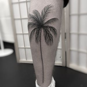 Get inked with a stunning tree and palm tree design by tattoo artist Oliver Whiting. Perfect for nature lovers!