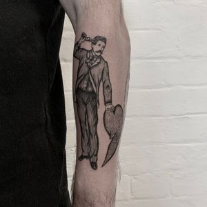 A beautifully crafted dotwork and illustrative tattoo featuring a traditional French man with a heart motif, created by the talented artist Ludo Matmut.