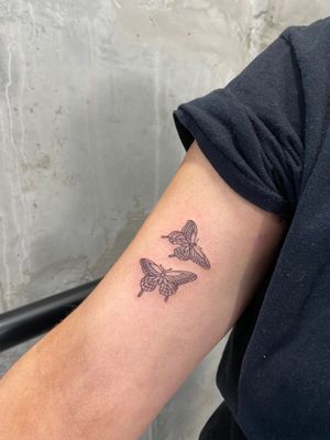 Get an intricately detailed fine line butterfly tattoo done by renowned artist Charlie Macarthur. A beautiful and delicate design perfect for anyone looking for a stylish tattoo.