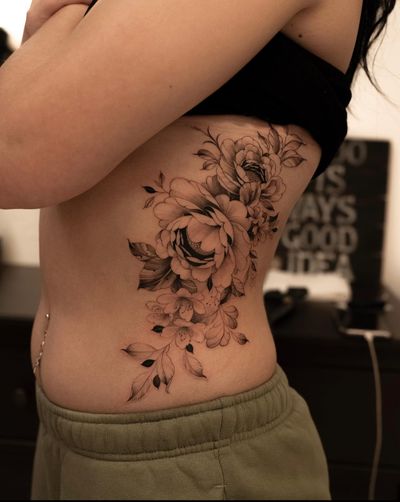 A beautifully intricate and delicate peony flower design by tattoo artist Ion Caraman, with fine line work and a floral motif.