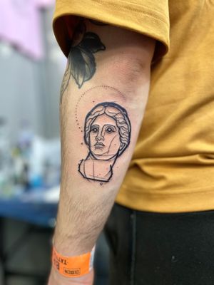 Capture the essence of art with this unique illustrative tattoo of a statue, expertly designed by tattoo artist Hannah Keuls.