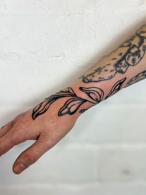 Adorn your skin with a stunning illustrative botanical leaf tattoo by the talented artist Jack Howard.