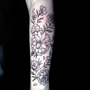 Express your love for nature with this intricate floral tattoo by the talented artist Ben Twentyman. Embrace the beauty of flowers on your skin today!