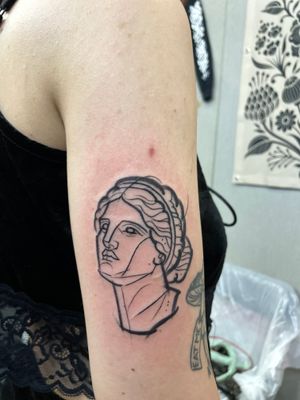 Get a unique illustrative tattoo of a statue sketched by talented artist Hannah Keuls.