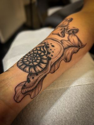 Get a unique illustrative snail tattoo with intricate dotwork shading, done by the talented artist Jack Howard.