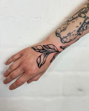 Elegant and intricate dotwork design featuring botanical elements like leaves and branches, artistically rendered by Jack Howard.