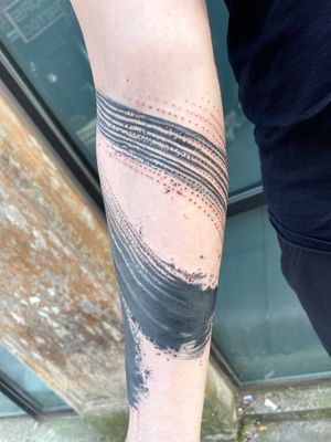Experience the unique blend of blackwork and watercolor styles in this beautiful brush motif tattoo by Hannah Keuls.