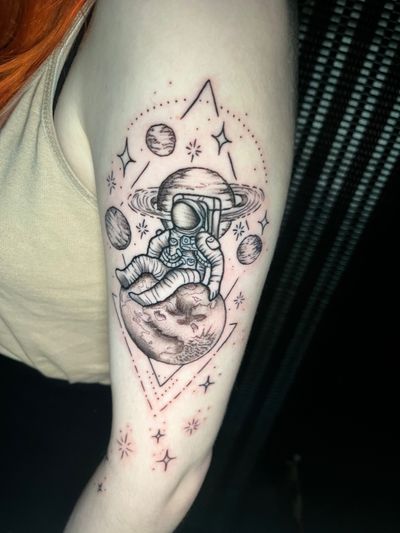 Experience a stellar journey with this dotwork tattoo by Ben Twentyman, featuring a mesmerizing mix of moons, planets, and astronauts.
