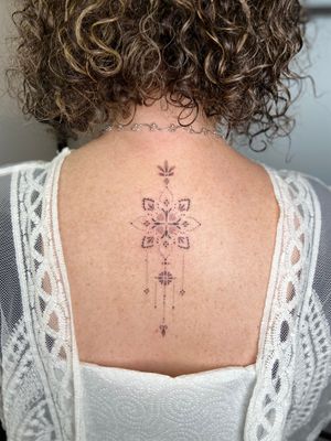 Experience the intricate beauty of this dainty mandala design by talented artist Viví Bogdanov. Perfect for those seeking a unique and delicate tattoo.