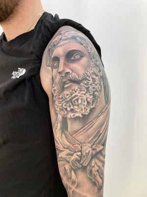 Elegant black and gray tattoo of a statue, expertly done by Hannah Keuls. Detailed and captivating design.