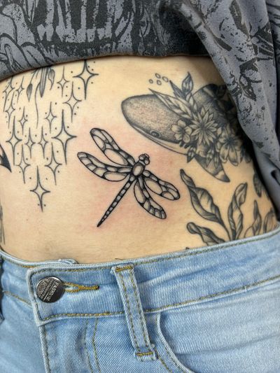 Experience the mesmerizing beauty of a dotwork dragonfly tattoo by the talented artist Jack Howard.
