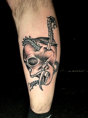 Get a striking illustrative tattoo featuring a snake, skull, and dagger by artist Ben Twentyman. Bold and intricate design for a unique and edgy look.