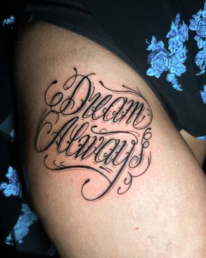 Get inspired by this small lettering tattoo that reminds you to dream away, created by tattoo artist Ben Twentyman.