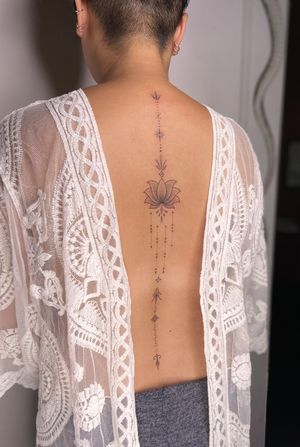 Experience the intricate beauty of dotwork and ornamental style with this dainty lotus and mandala design by tattoo artist Viví Bogdanov.