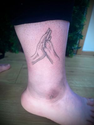 Illustrative hand tattoo featuring a paw giving a high five, expertly designed by Nat with intricate dotwork and fine lines.