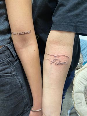 Get a delicate fine line tattoo by Eve inksane featuring hands, family motif, and roman numerals for a meaningful and timeless design.