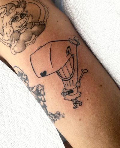 Get inked with a whimsical illustrative tattoo of a whale in comic style by the talented artist Miss Vampira.