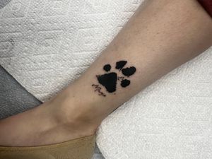 Get inked with a unique illustrative paw print pet tattoo by Miss Vampira, a perfect homage to your four-legged friend.