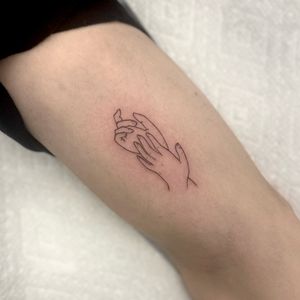 Discover the elegance of fine line and illustrative style in this minimal outline hand tattoo by Miss Vampira.