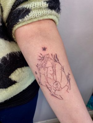 A beautifully detailed fine line and hand-poked tattoo by Charlotte Pokes, depicting a symbolic connection to family through nature.
