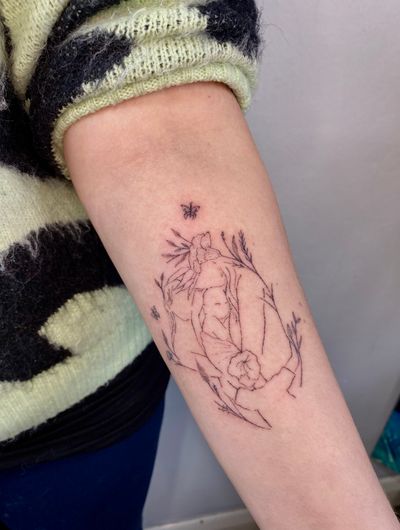 A beautifully detailed fine line and hand-poked tattoo by Charlotte Pokes, depicting a symbolic connection to family through nature.
