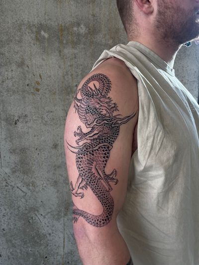 Immerse yourself in the power and beauty of this Japanese illustrative dragon tattoo masterpiece, expertly crafted by the talented artist Rich Sinner.