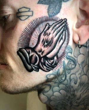 Get a beautiful black and gray traditional tattoo of praying hands by the talented artist Angel Face. Illustrative style with intricate details.