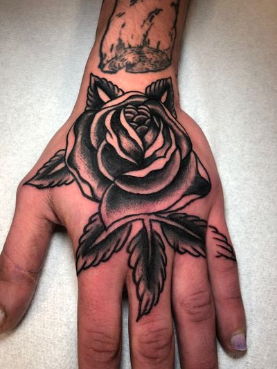 Beautiful black & gray rose tattoo by Angel Face, combining traditional style with elegant flower motif.