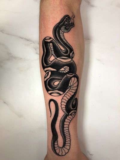 Capture the bold and fierce nature of a traditional snake tattoo with expert artistry by Angel Face. Embrace the power and mystique of this ancient motif.
