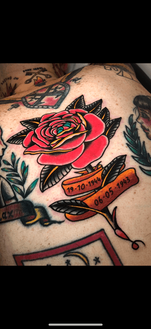 Capture the beauty of a classic rose and ribbon design with this traditional tattoo by renowned artist Angel Face.