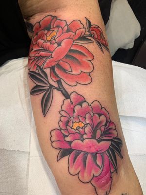 Get inked with a stunning traditional peony flower tattoo designed by the talented artist Angel Face.