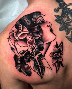 Experience the mystique and allure of a traditional black and gray gypsy woman tattoo by Angel Face.