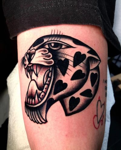 Get a fierce and timeless traditional panther tattoo done by the talented artist Angel Face. Achieve a bold and striking look with this classic design.