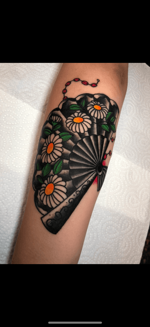 Capture the elegance of traditional Japanese art with an illustrative fan tattoo by Angel Face. Embrace the beauty of simplicity and intricate details in this timeless design.