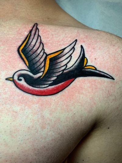 Get a classic and timeless swallow tattoo done by Angel Face in traditional style. Perfect for those seeking a traditional look with a touch of vintage charm.