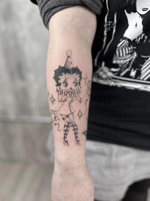 Get a stunning dotwork, fine line, and illustrative tattoo of Betty Boop in pin up style by the talented artist Laura May.