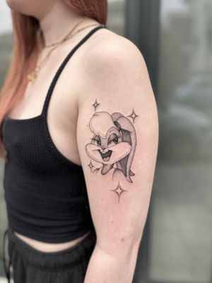 Get an anime-inspired dotwork tattoo of Lola Bunny from Space Jam by artist Laura May. A fun twist on Looney Tunes nostalgia.