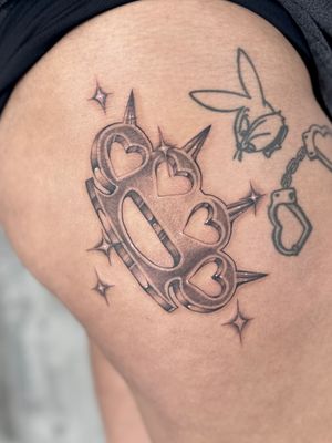 Unique dotwork and fine line design by Laura May featuring a heart intertwined with brass knuckles. Perfect balance of softness and strength.