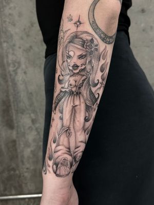 Get a stunning black and gray illustrative tattoo of a Bratz doll in chicano style by artist Laura May.