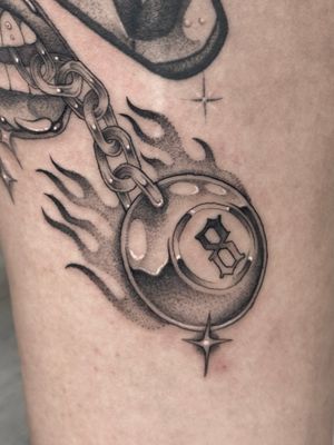 An illustrative tattoo by Laura May featuring a keychain and an eight ball, created using intricate dotwork technique.